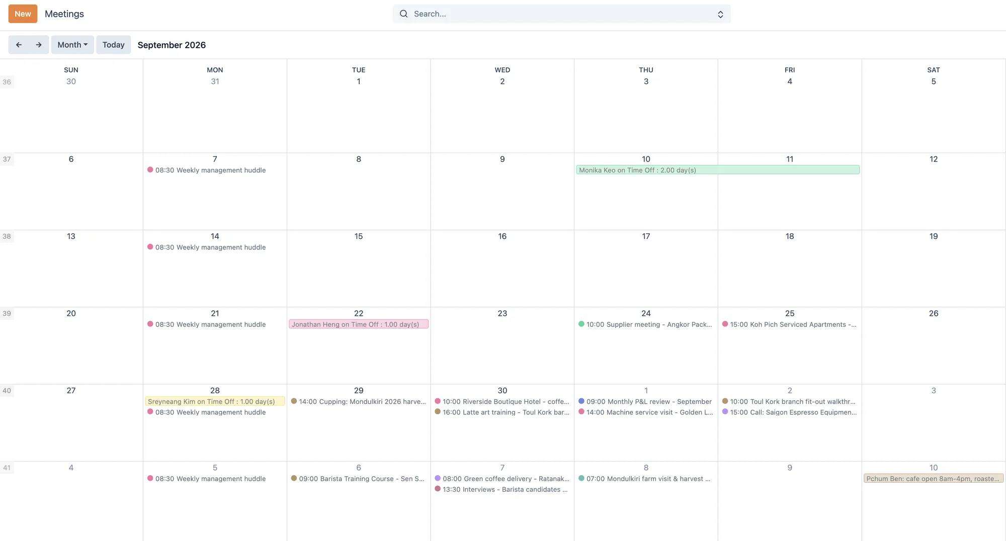 Kyu calendar month view with team meetings, supplier visits, training sessions, and employee time off